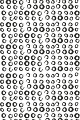 A repeating black and white pattern made up of hand-drawn, irregular small circles scattered randomly on a clean white background. Peel and stick removable wallpaper.