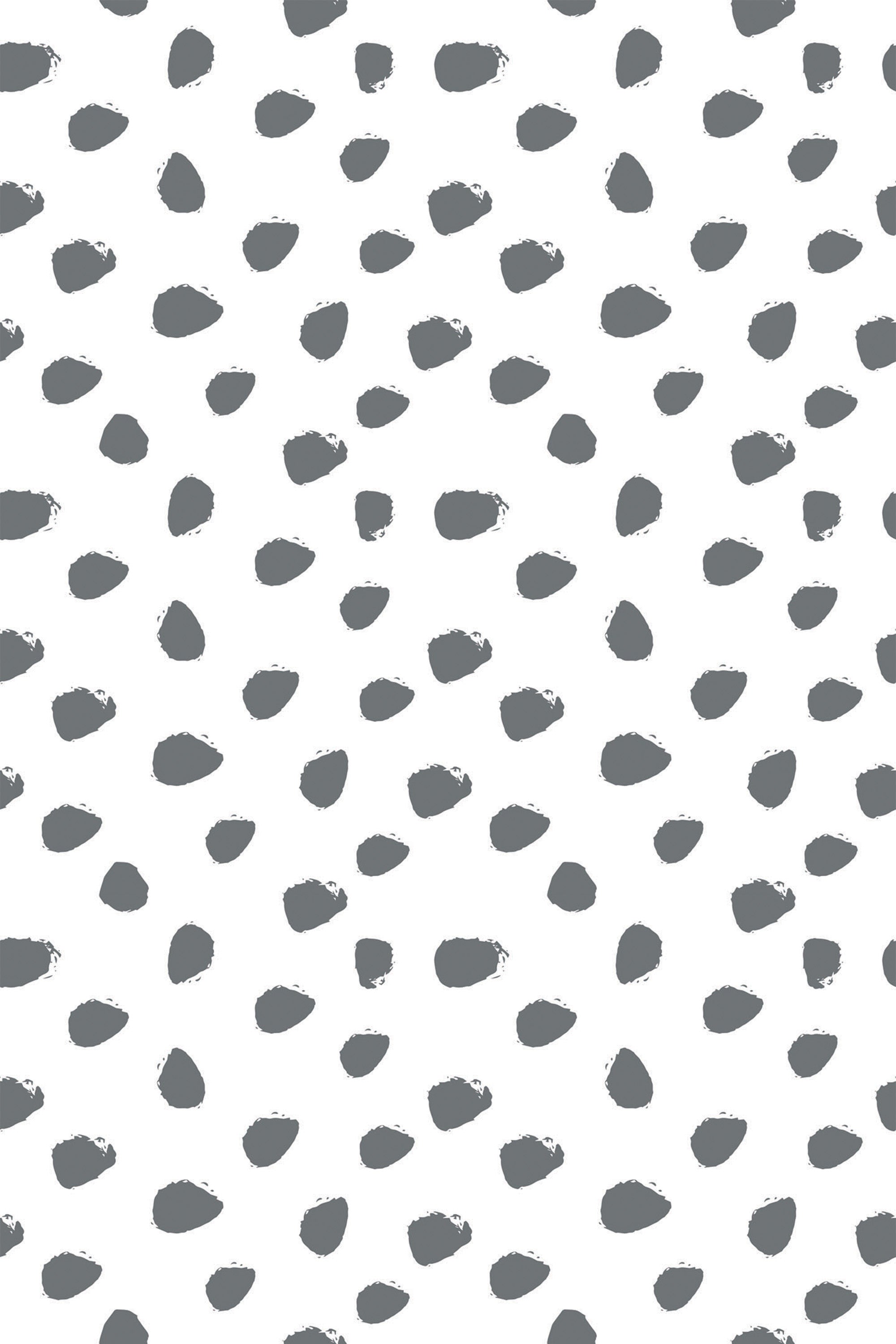 Irregular dark gray dots are scattered across a white background in a random pattern. Peel and stick removable wallpaper.