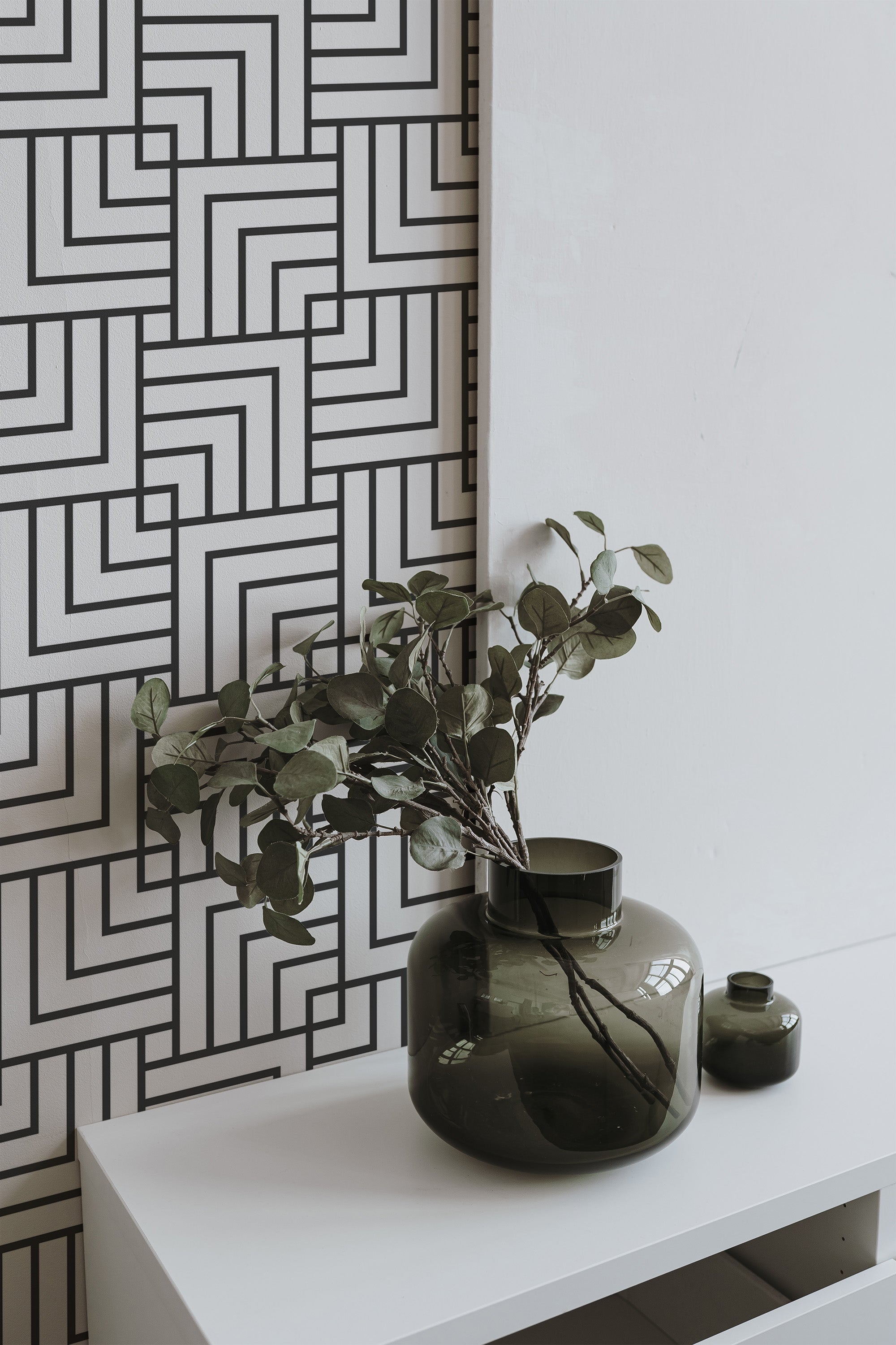 Self-adhesive wallpaper with a modern square pattern composed of black intersecting lines on a white background.