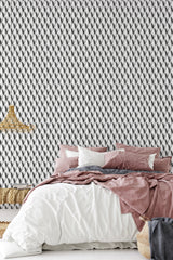 Wallpaper with an Art Deco leaf pattern of repeated, symmetrical, black and white leaf shapes creating a bold, geometric design. Traditional wallpaper.