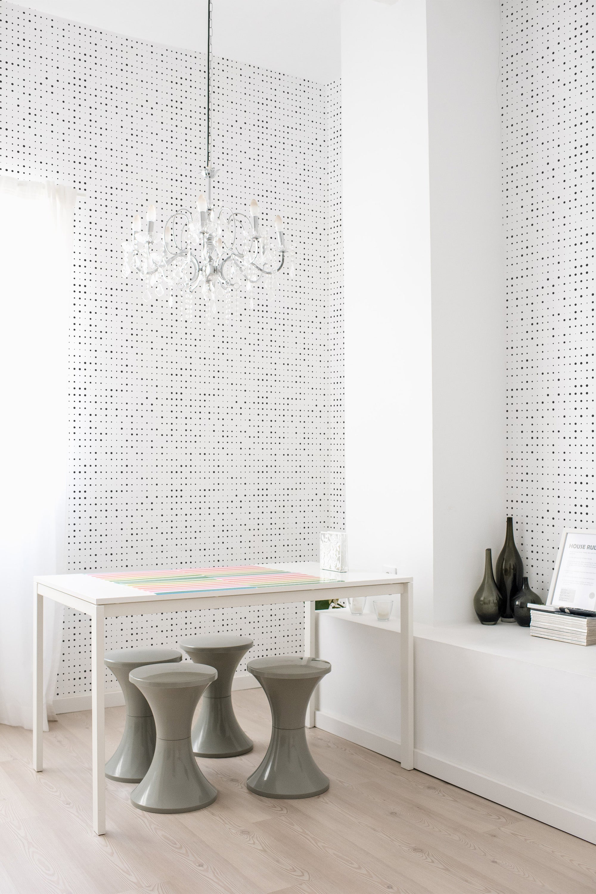 The room has walls covered in a halftone-patterned wallpaper with small, evenly spaced black dots on a white background, creating a subtle gradient effect. Traditional wallpaper.