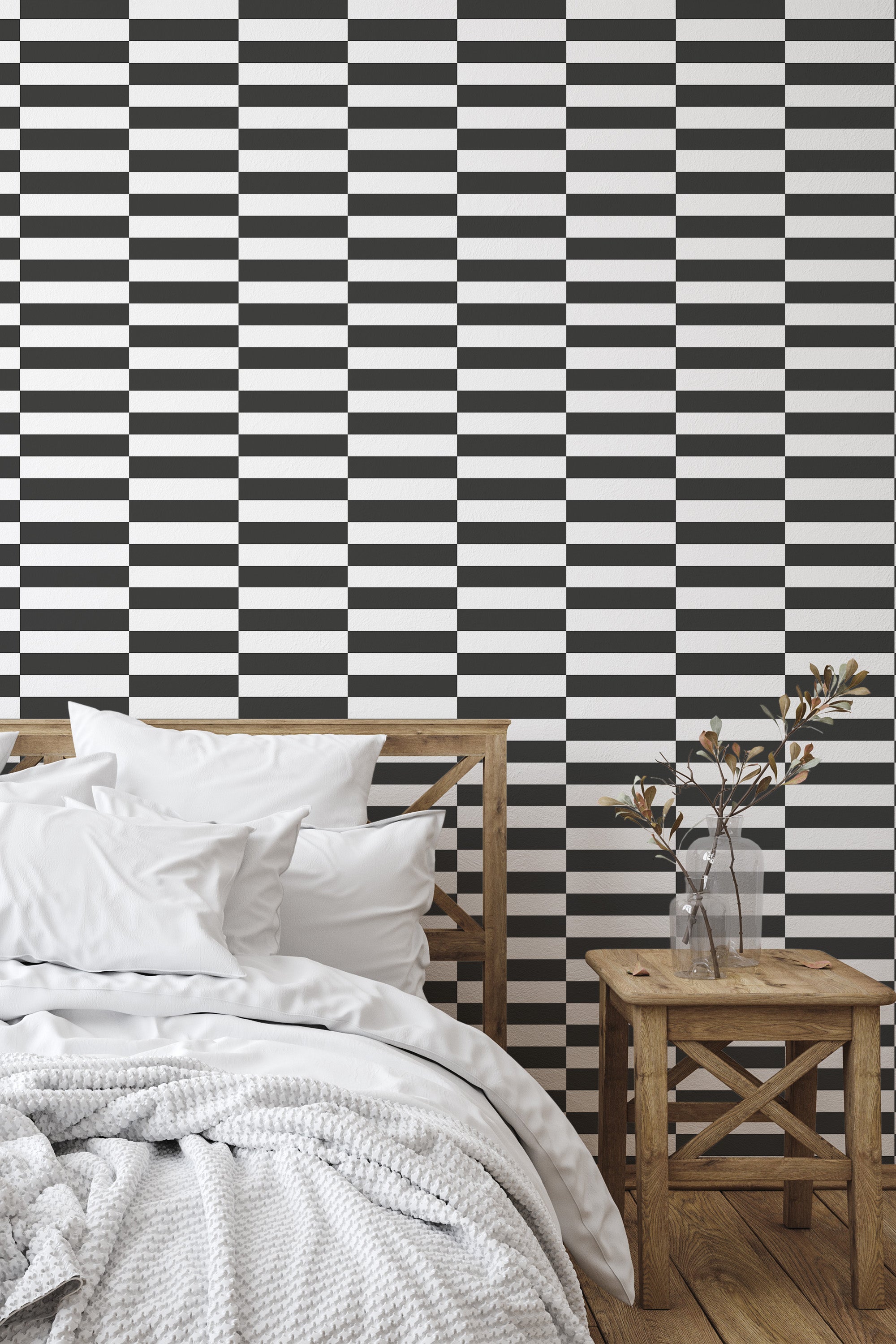Self-adhesive checkerboard wallpaper in a minimalist bedroom setting, featuring alternating black and white squares creating a bold, geometric pattern.