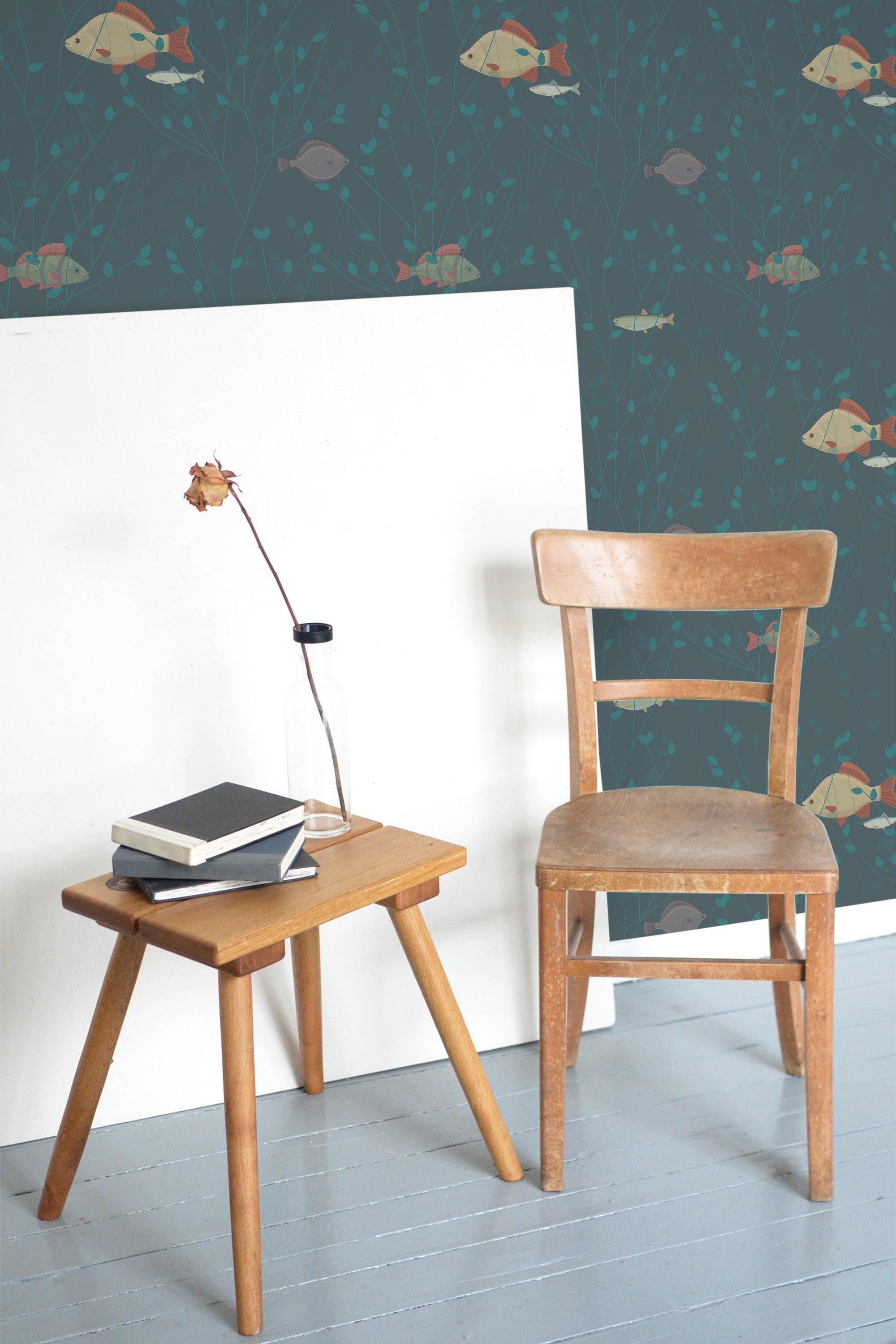 Self-adhesive wallpaper with a whimsical fish design in various shades of orange, white, and blue swimming against a dark teal background with delicate green aquatic plants.