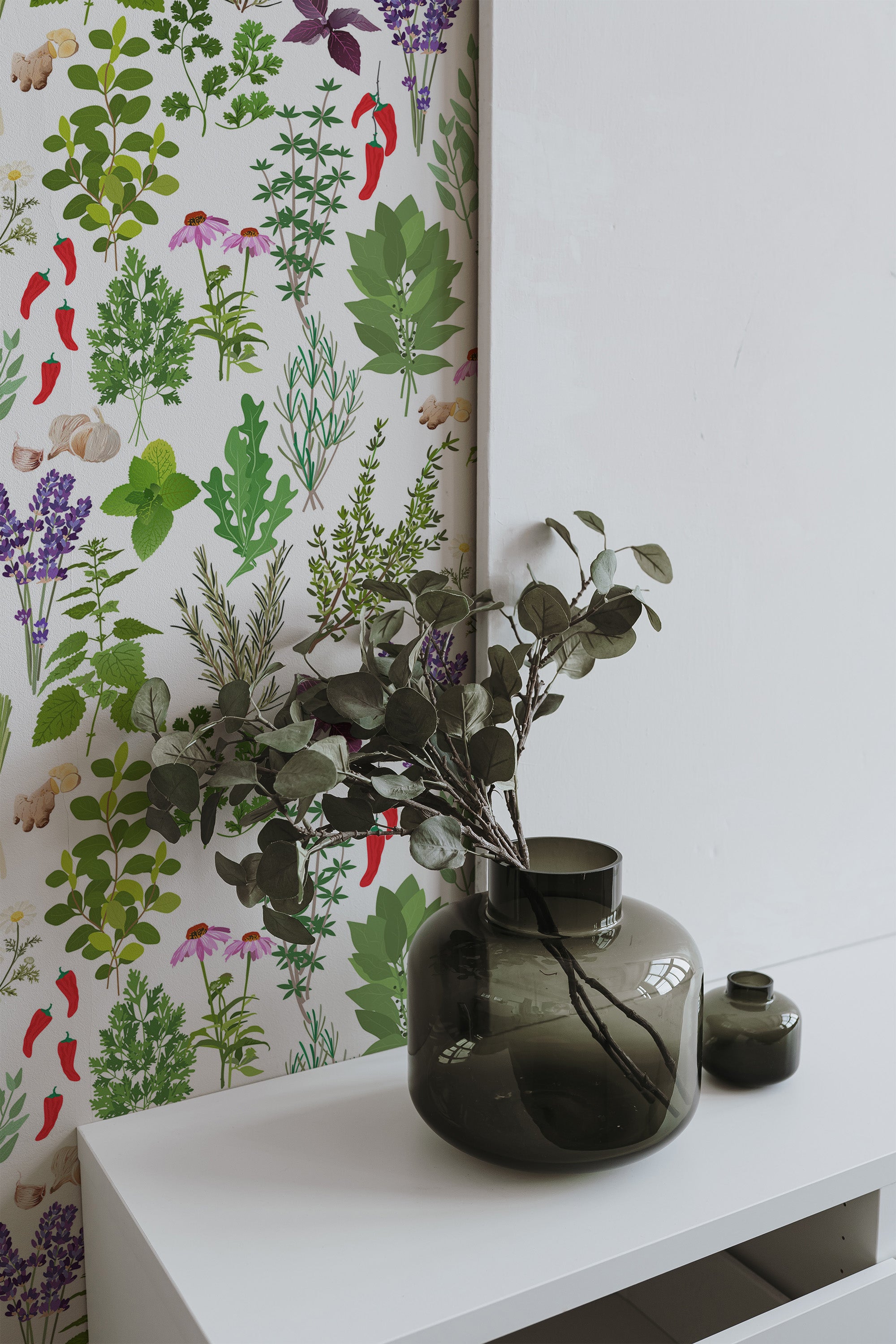 Self-adhesive wallpaper with a vibrant herb pattern of green leaves, lavender, red chili peppers, and other colorful plants on a white background.