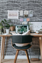 Self-adhesive wallpaper with an intricate black and white linear pattern forming a mesh-like design, adding texture and depth to the room.