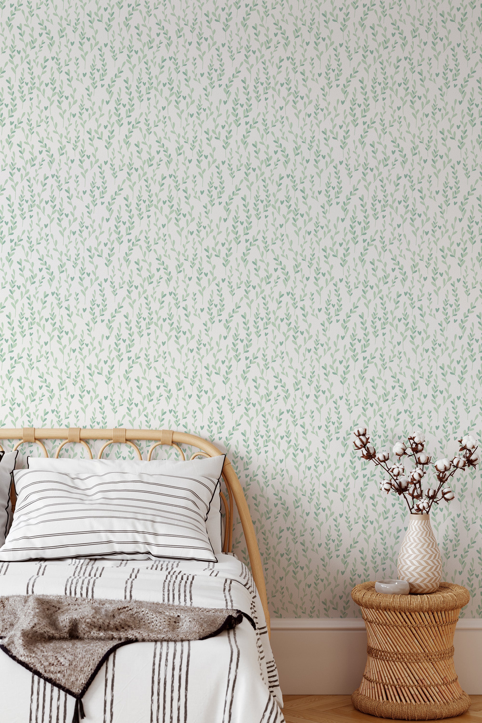 Self-adhesive wallpaper with a delicate pattern of simple green leaves scattered across a soft white background.