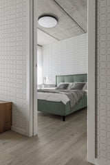 A room with wallpaper in a subtle square lines pattern, offering a clean and modern texture to the space. The design provides a steady, repeating geometric element that adds depth without overwhelming the room���s decor. Traditional wallpaper.
