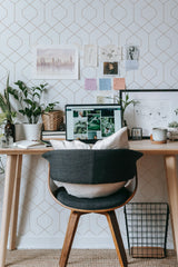 Self-adhesive wallpaper with a geometric rhombus pattern in a subtle, minimalist design, placed in a modern workspace setting.