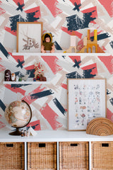 Self-adhesive wallpaper with an abstract brush stroke pattern in bold reds, blues, and off-whites, adding a dynamic, modern touch to the room.