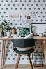 Self-adhesive wallpaper with a Flower star design, featuring a repetitive pattern of dark, geometric star-shaped flowers on a white background, creating a modern and minimalist aesthetic in the room.