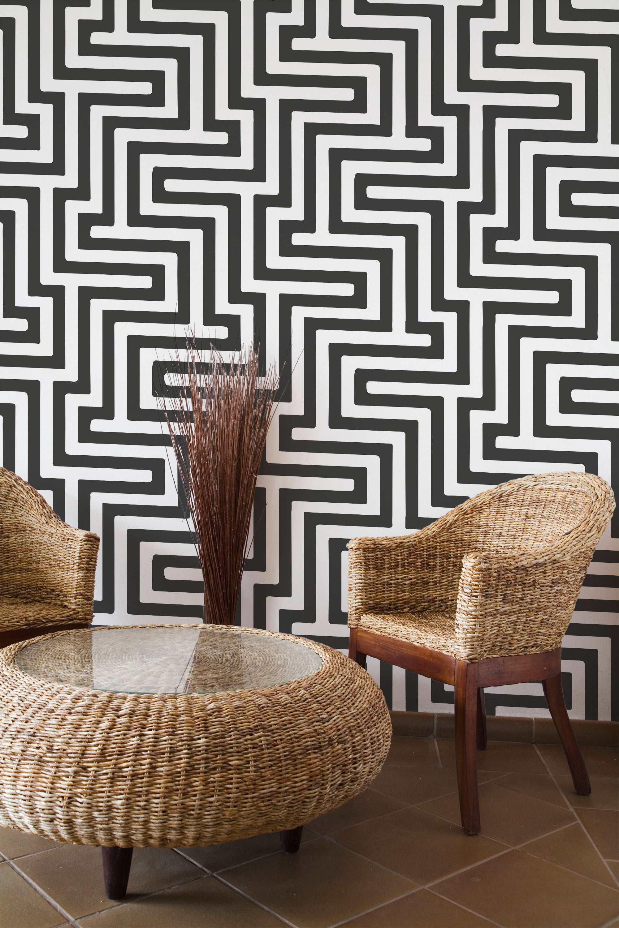 Self-adhesive black and white geometric wallpaper with bold interlocking maze-like patterns, creating a striking modern design.
