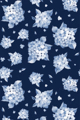 Blue and white floral clusters scattered on a deep navy background with delicate leaves and small petals. Peel and stick removable wallpaper.