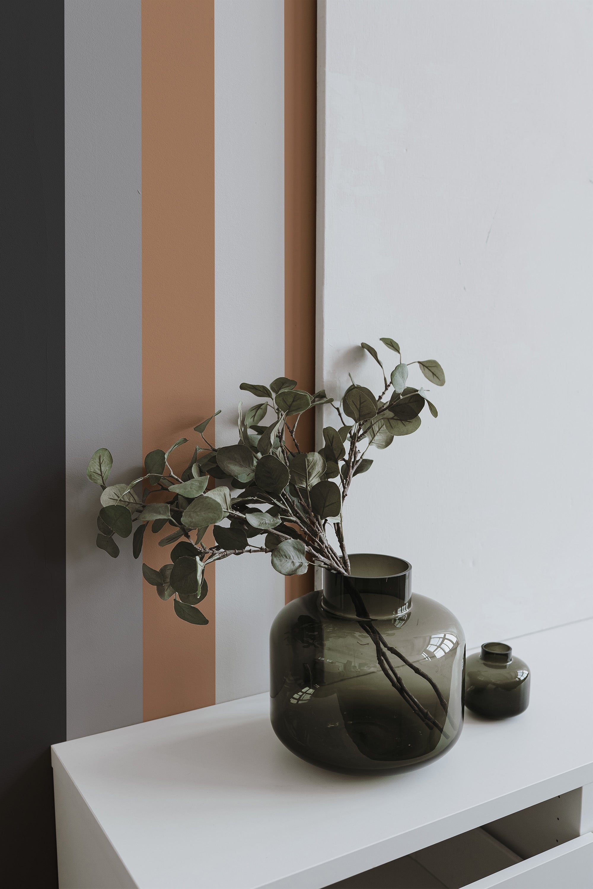 Self-adhesive wallpaper with classic stripe design in muted tones of gray, beige, and black.