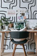 Self-adhesive wallpaper with an abstract brush stroke line design in black, creating a bold, modern pattern on a white background.