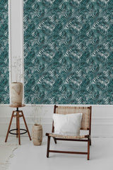 A room with blue tropical leaf wallpaper, highlighting lush green leaves against a muted background, creating a fresh and serene atmosphere. Traditional wallpaper.