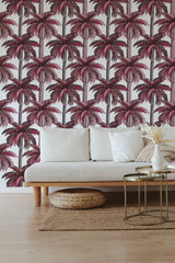 Pink palm trees with detailed leaves and slender trunks printed in a repeating pattern on a white background, creating a vibrant tropical aesthetic in a traditional wallpaper.