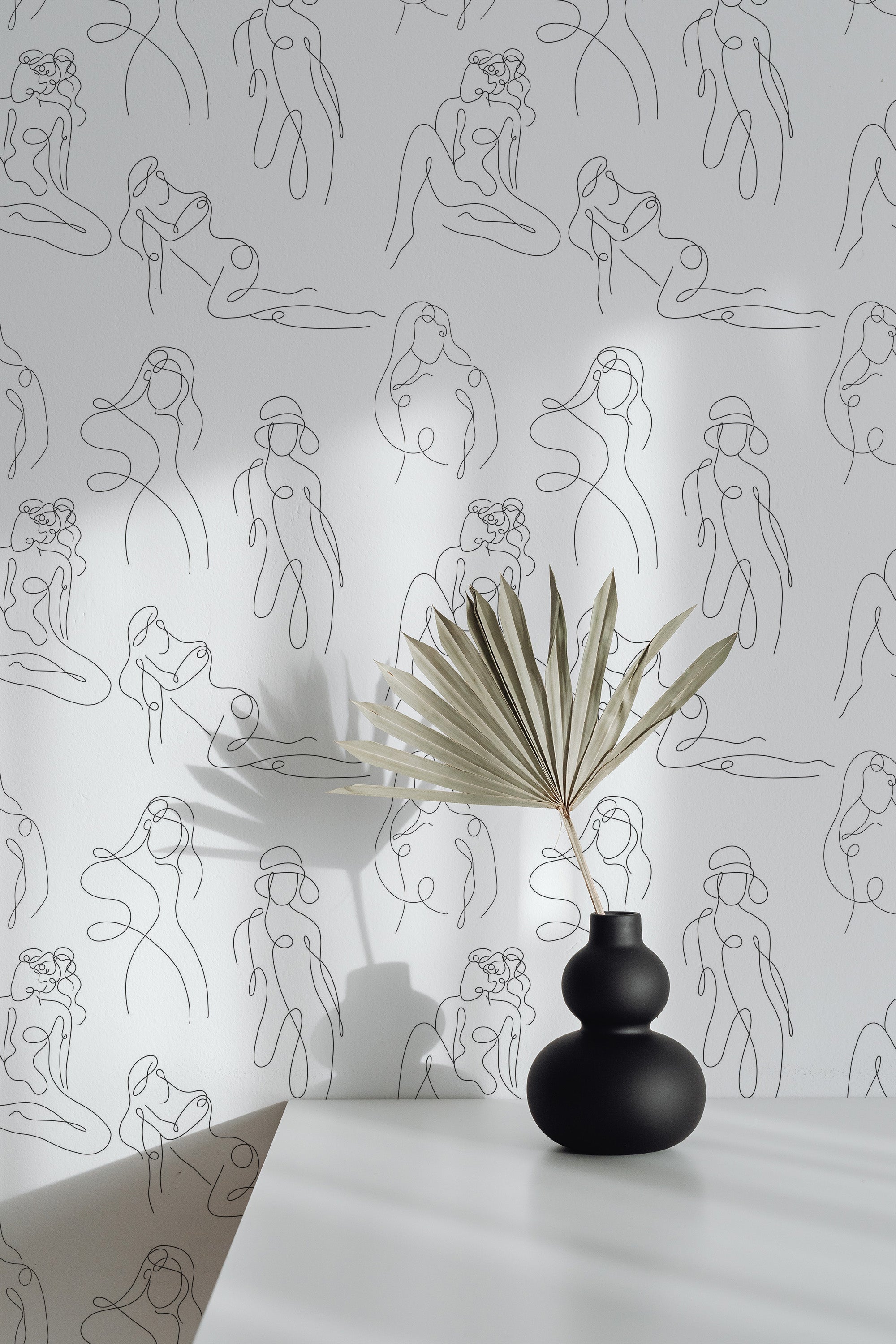 Self-adhesive wallpaper with minimalist body line art of intertwined human figures in black on a white background, creating a modern, sophisticated aesthetic.