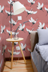 Self-adhesive wallpaper with a bird pattern, displaying elegant white birds with outstretched wings against a muted reddish-pink background. The birds are intricately detailed with touches of black and gold, creating a lively yet serene atmosphere in the room.