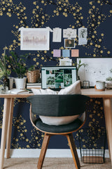 Self-adhesive wallpaper with a golden tree design, set against a dark background, featuring delicate golden branches with naturalistic clusters of small, blooming flowers.