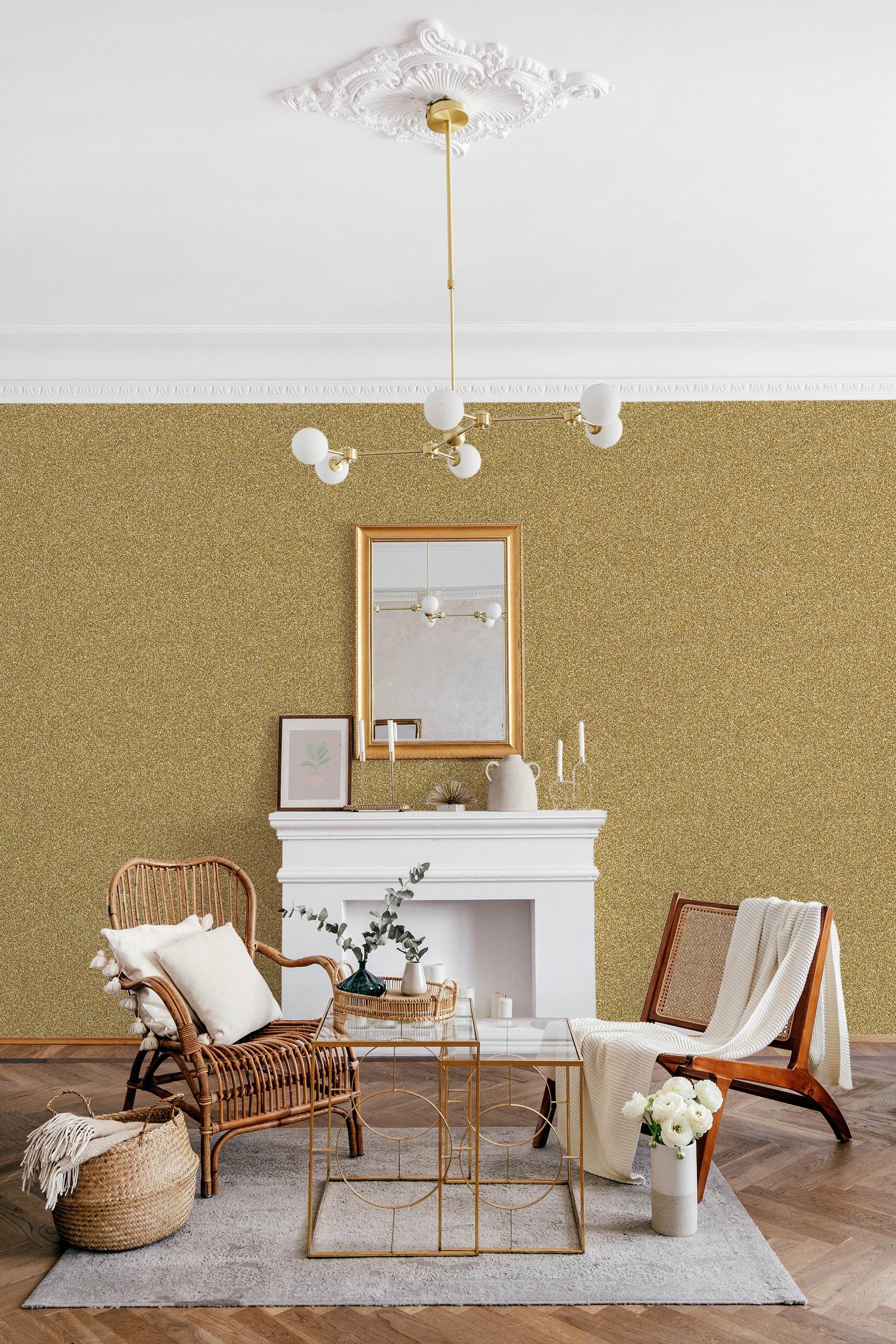 A room with a soft golden glitter pattern wallpaper, complementing a traditional aesthetic with ornate ceiling molding, a gold-framed mirror, and classic wicker furniture. Traditional wallpaper.