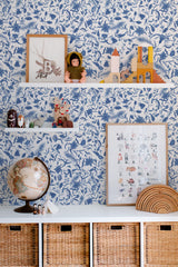 Self-adhesive wallpaper in a blue farmhouse design with detailed botanical patterns, including leaves and flowers, creating a vintage-inspired, country-chic aesthetic in the room.