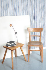 Self-adhesive wallpaper with an abstract vertical pattern of blue and gray lines, creating a soft, calming atmosphere.