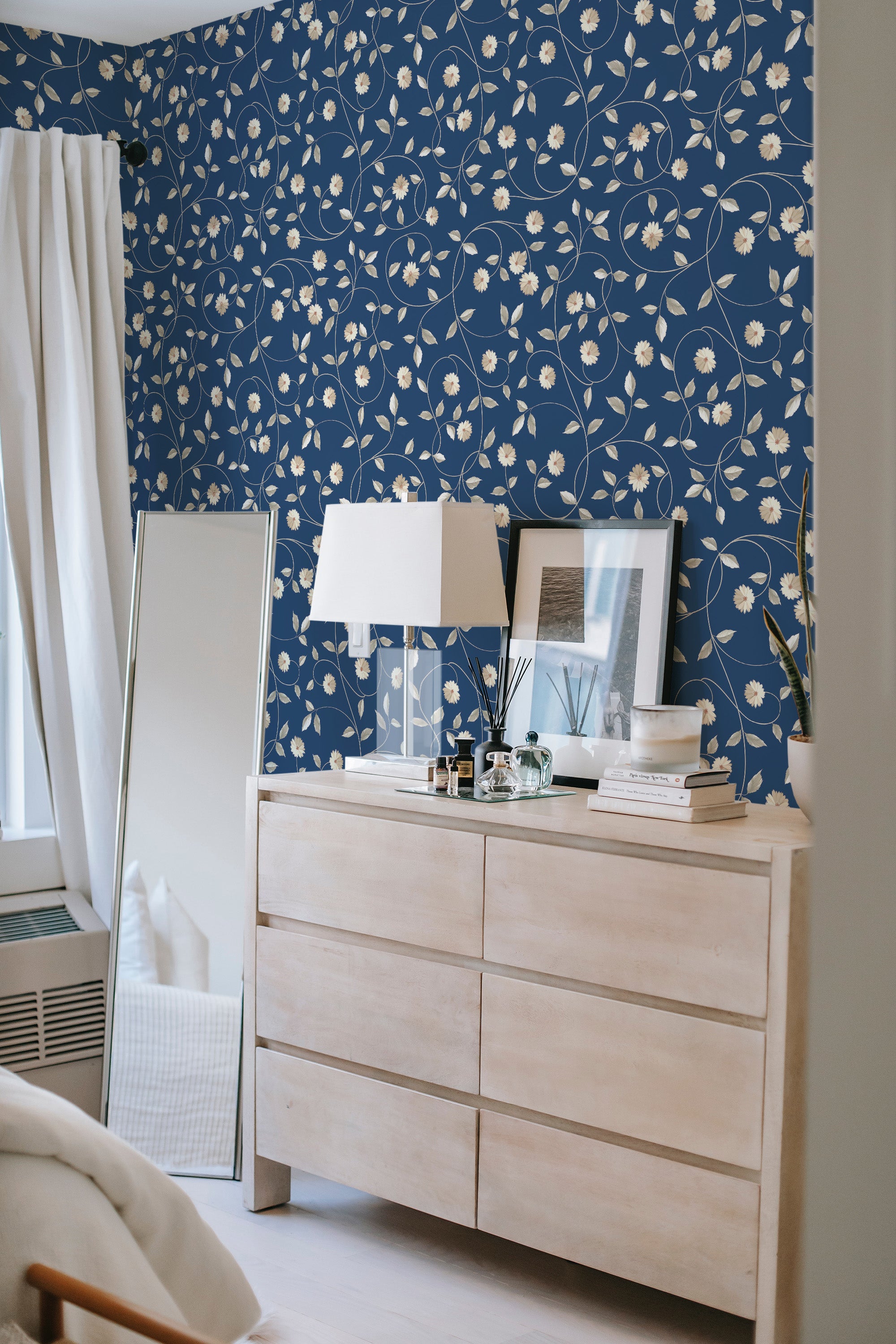 A room with a Blue golden floral wallpaper. The blue background with swirling golden stems and white flowers creates a traditional wallpaper.