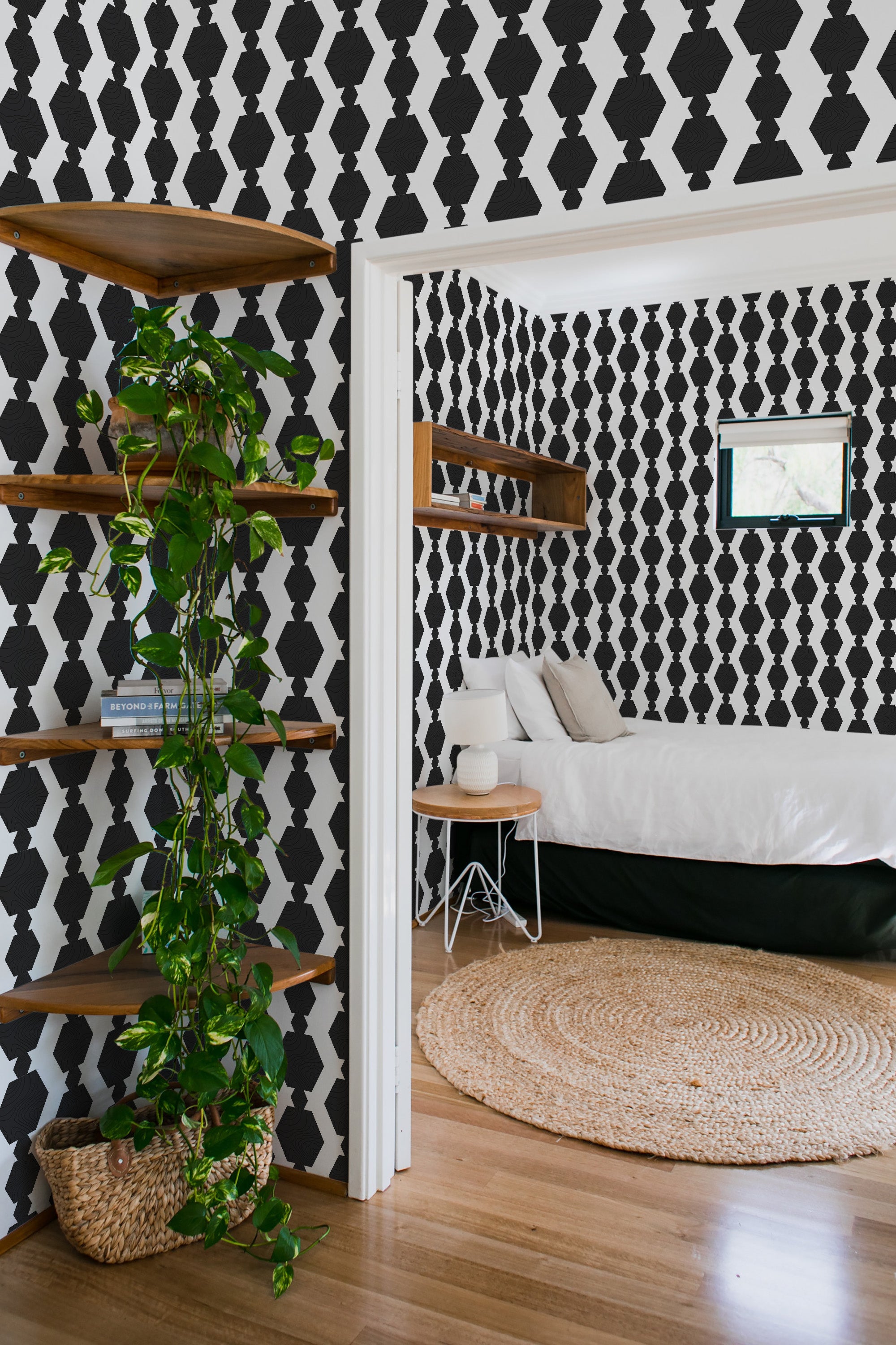 Black bold geometric wallpaper with repeating diamond and hexagon shapes in a striking contrast against a white background in a traditional wallpaper design.