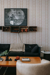 A room with wallpaper with an intricate Ethnic stripe pattern in neutral tones, creating a warm and inviting atmosphere. Traditional wallpaper.