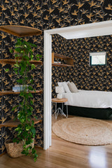 Room with dark wallpaper adorned with golden flower patterns, giving the space a sophisticated and elegant look. Traditional wallpaper.