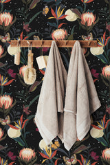 Self-adhesive wallpaper with a botanical design of vibrant protea flowers, butterflies, and lush green leaves on a dark background.