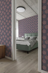 Room with walls covered in a purple wallpaper adorned with repeating patterns of pink flowers, creating a lively and vibrant atmosphere. Traditional wallpaper.