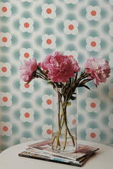 Self-adhesive Mid-century geometric flower wallpaper with stylized flowers in a repeating pattern, featuring soft blue and green circular shapes with contrasting orange centers against a light background.
