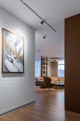 Wallpaper with a repetitive leaf tile pattern in subtle shades of beige and gray, creating an elegant geometric arrangement. Traditional wallpaper.