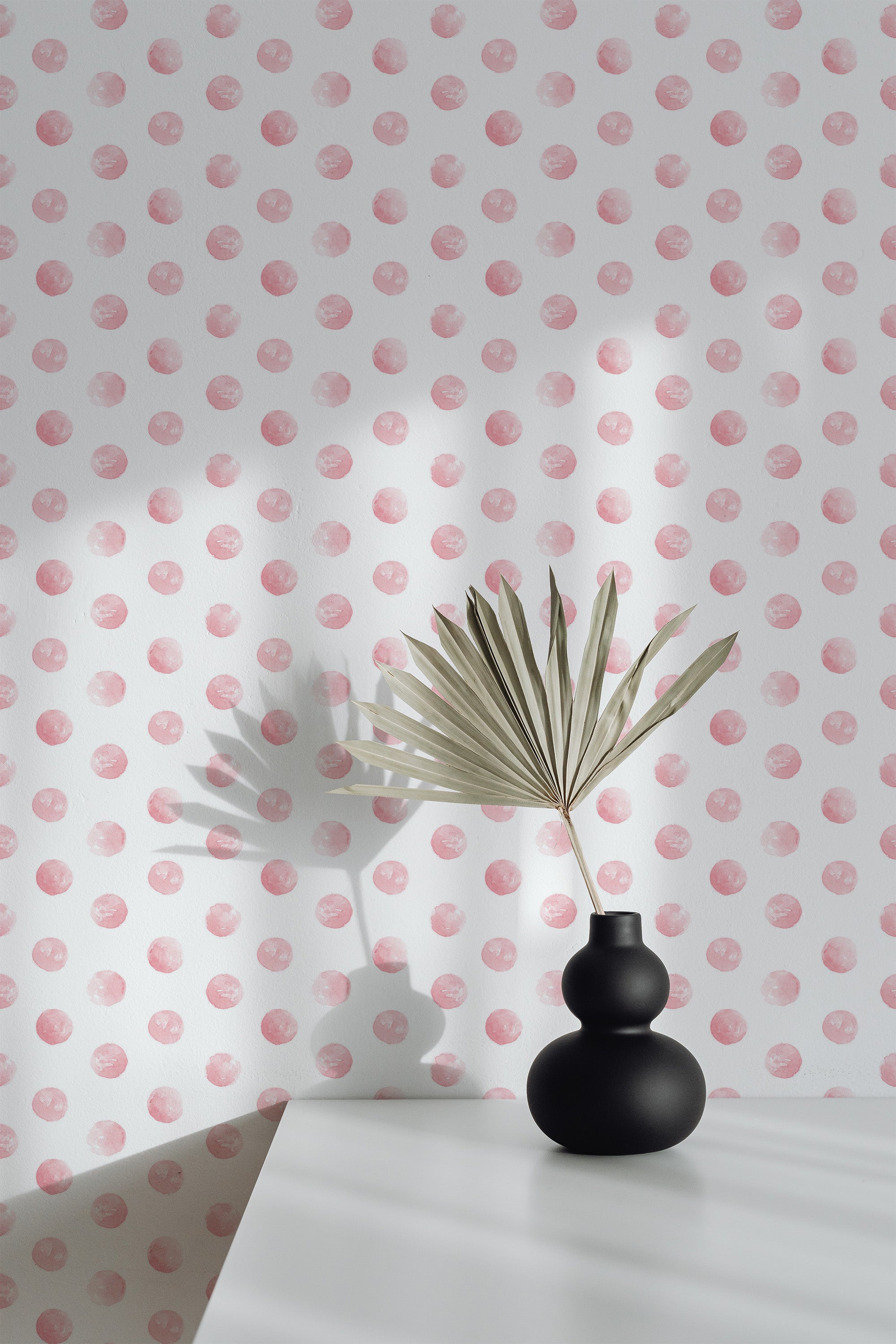 Self-adhesive pink watercolor polka dot wallpaper with soft, irregular dot patterns on a white background, adding a subtle and playful accent to the room.