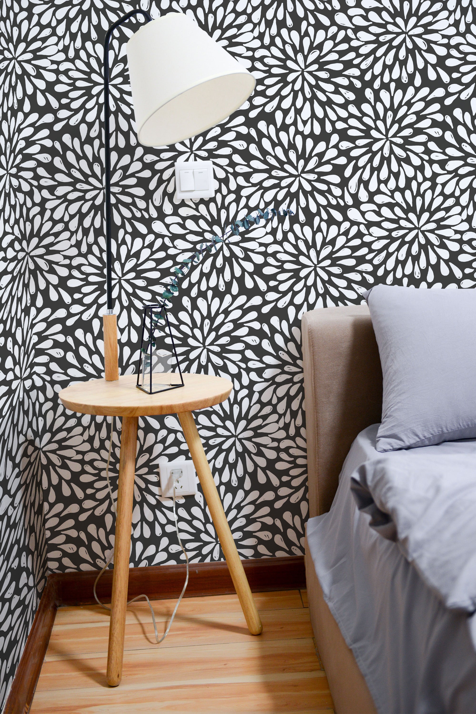Self-adhesive wallpaper with a bold abstract floral pattern in white against a dark background, creating a striking contrast.