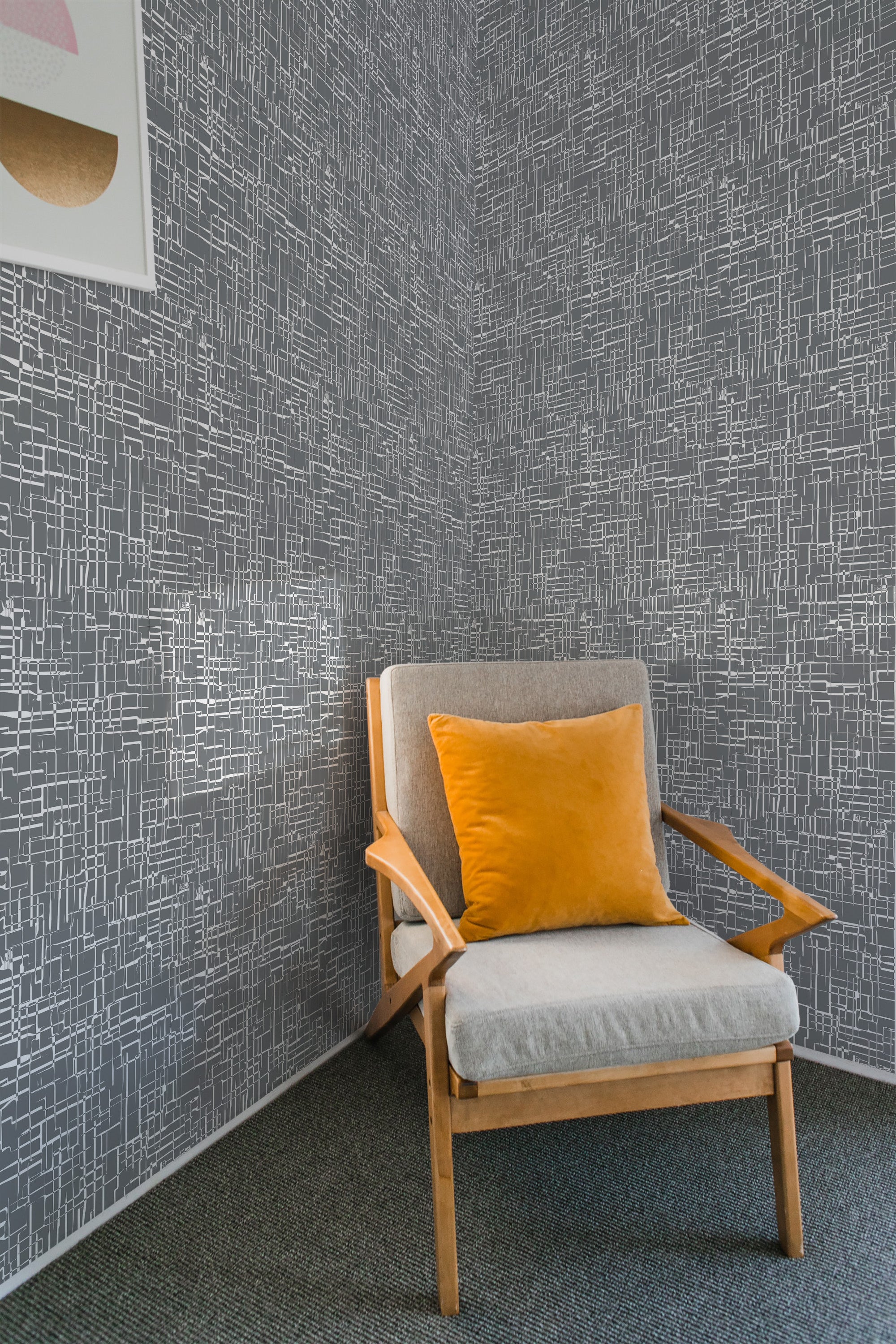 A room with vintage abstract grid wallpaper in intersecting white lines on a dark gray background, creating a geometric, mid-century modern look. Traditional wallpaper.
