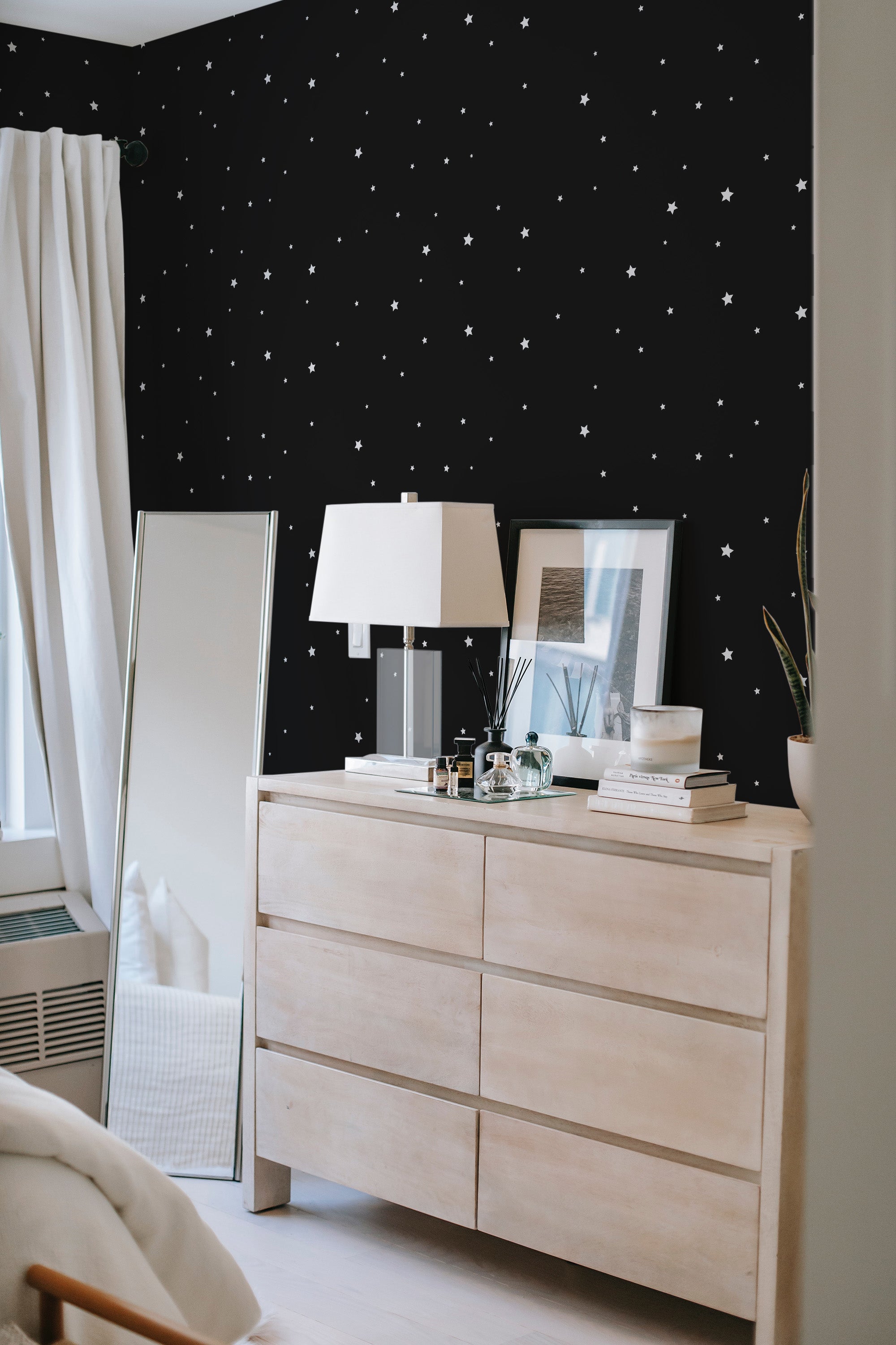 Wallpaper with a black background is adorned with small, evenly spaced white stars, creating a contrast that enhances the room's minimalist decor. Traditional wallpaper.