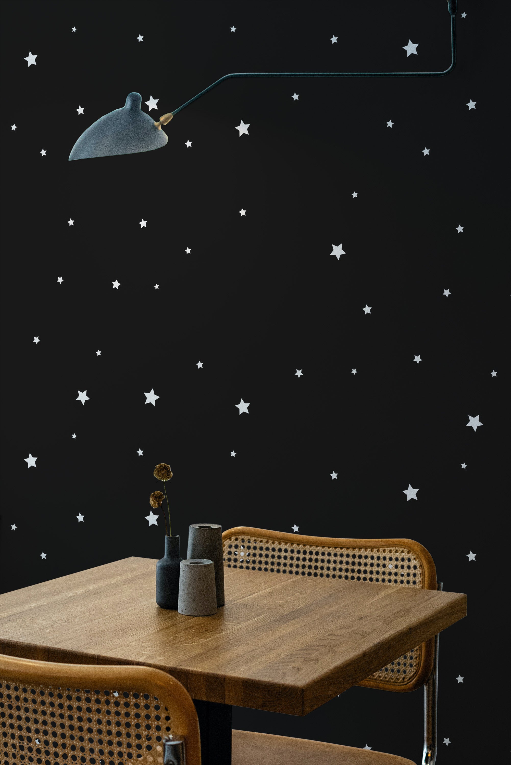 Self-adhesive wallpaper with a black base adorned with small white stars spread across the design, creating a minimalistic and celestial atmosphere.