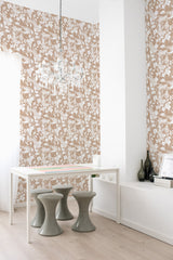 A room with brown wallpaper adorned with intricate white floral patterns, creating an old-school, vintage feel. This is traditional wallpaper.