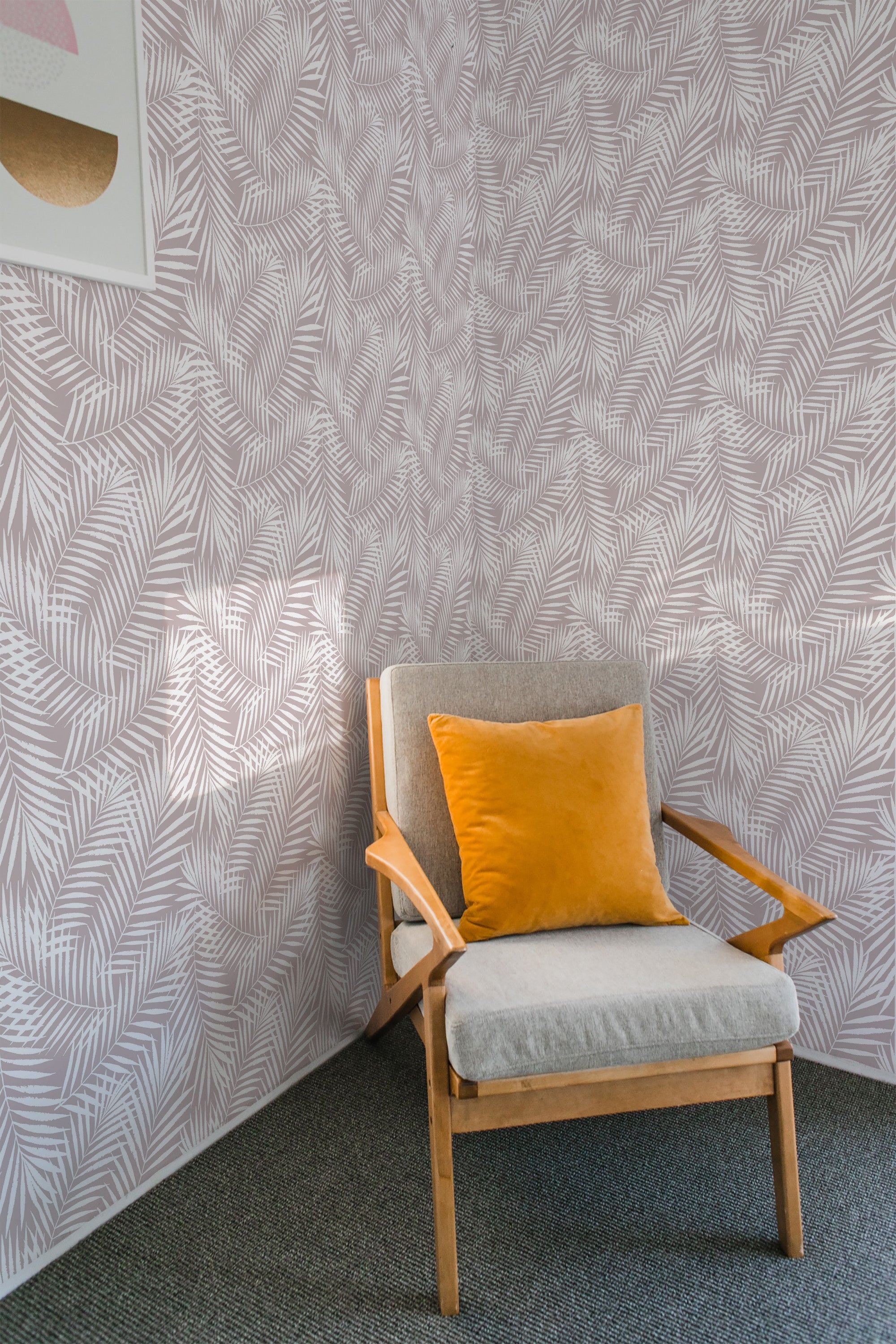 A room with a chair in front of a wall covered in a jungle palm leaf patterned wallpaper in a light color scheme, invoking a traditional wallpaper feel.