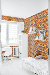 A brightly lit room with walls covered in orange retro circle patterned traditional wallpaper.