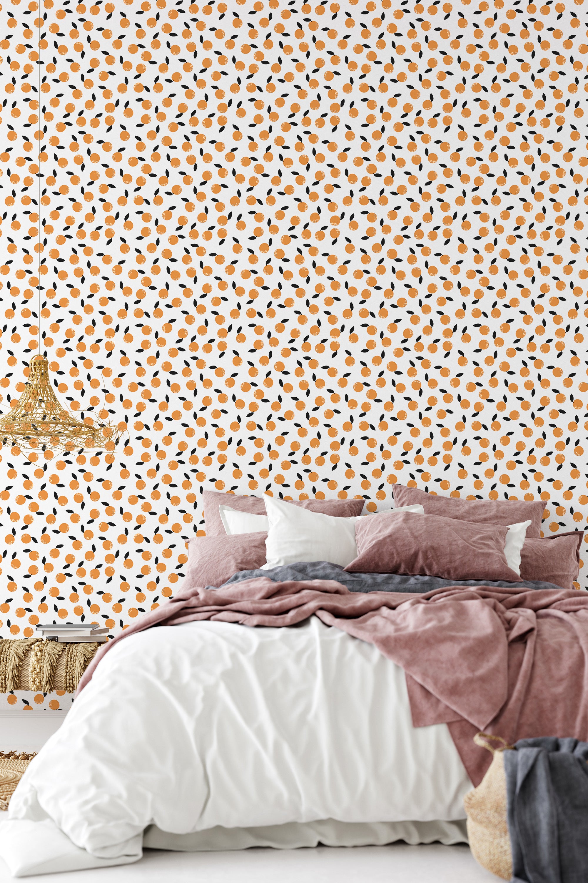 A bedroom with a wall covered in orange-fruit-patterned wallpaper, accented by a plush bed with dusty pink and white bedding, traditional wallpaper.