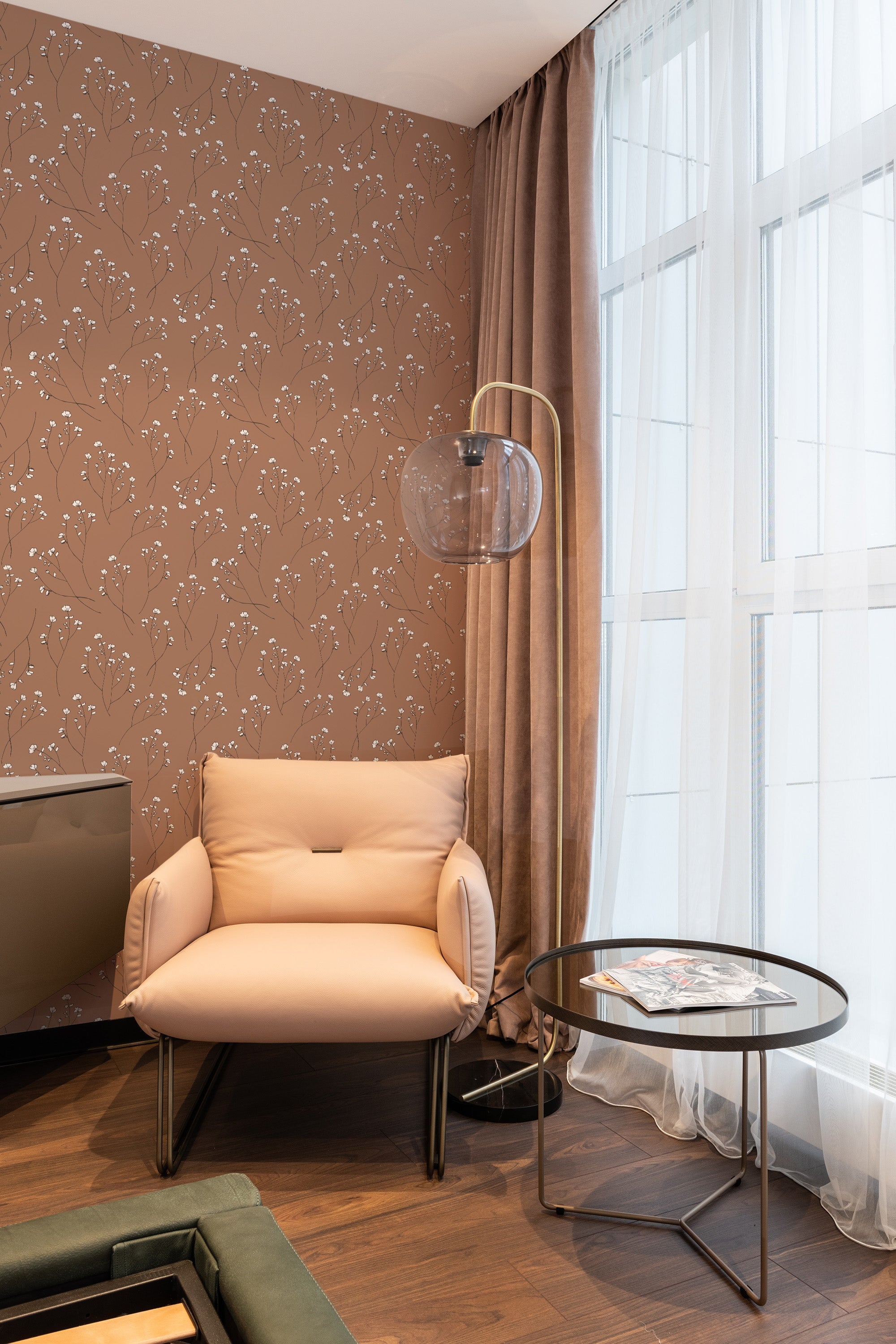 A room with walls adorned in Delicate neutral floral wallpaper, showing a pattern of subtle flowers and stems on a beige background, next to drapes and furniture, embodying a traditional wallpaper aesthetic.