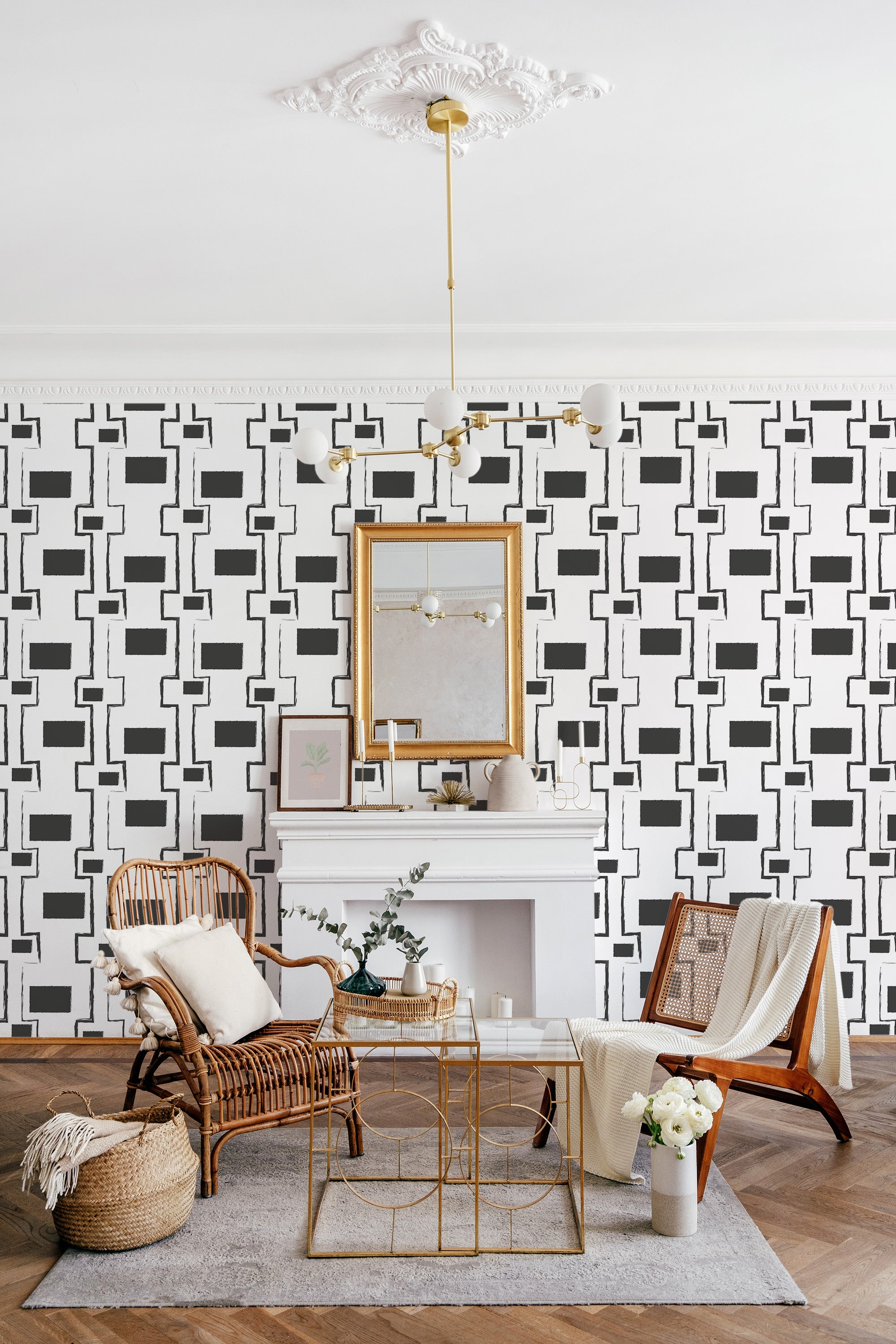 A room with bold geometric stroke wallpaper, consisting of interlocking black shapes on a white background, adding a modern twist to traditional wallpaper.