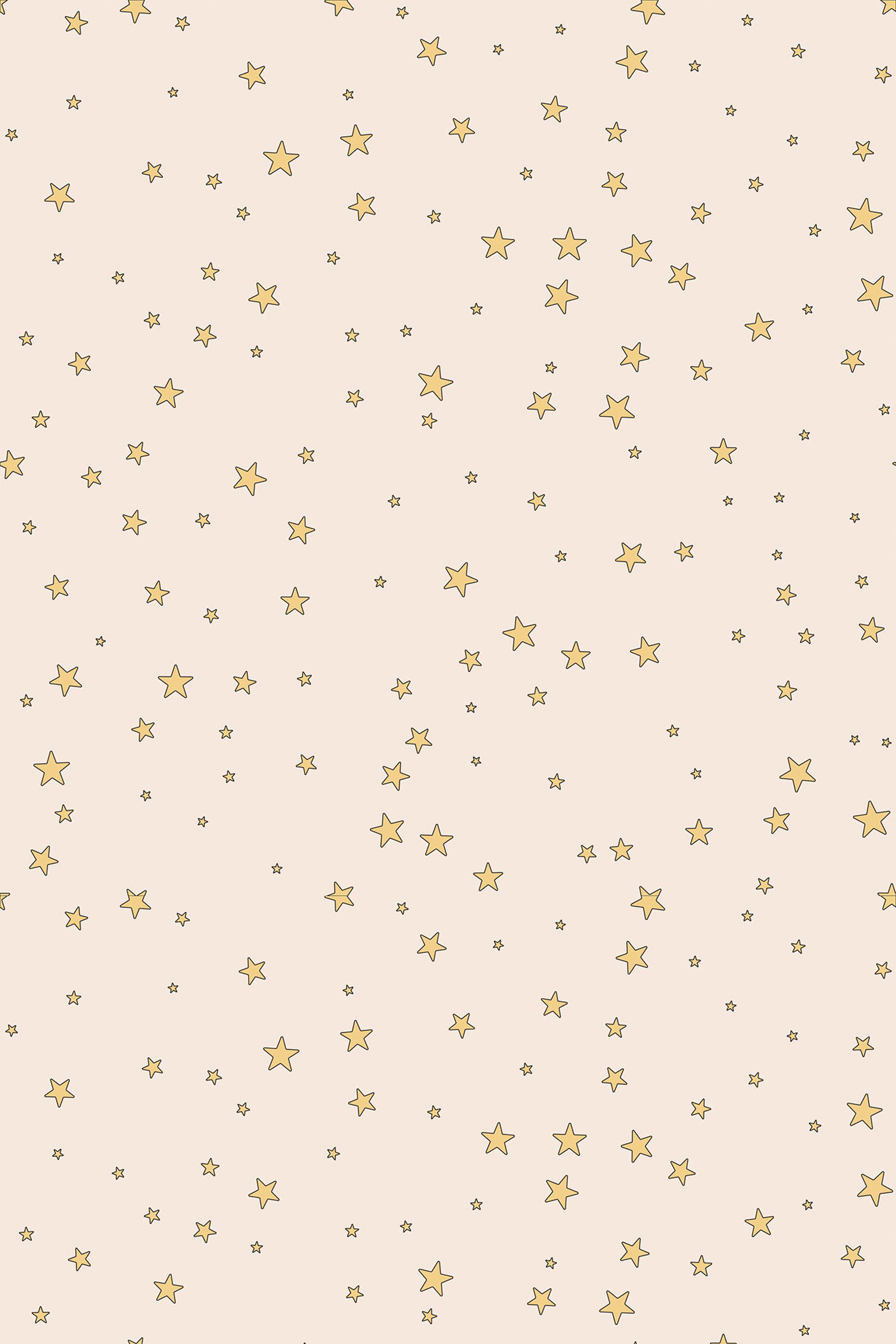 Pattern of small and large golden stars scattered on a pale background, ideal for a child's room, peel and stick removable wallpaper.