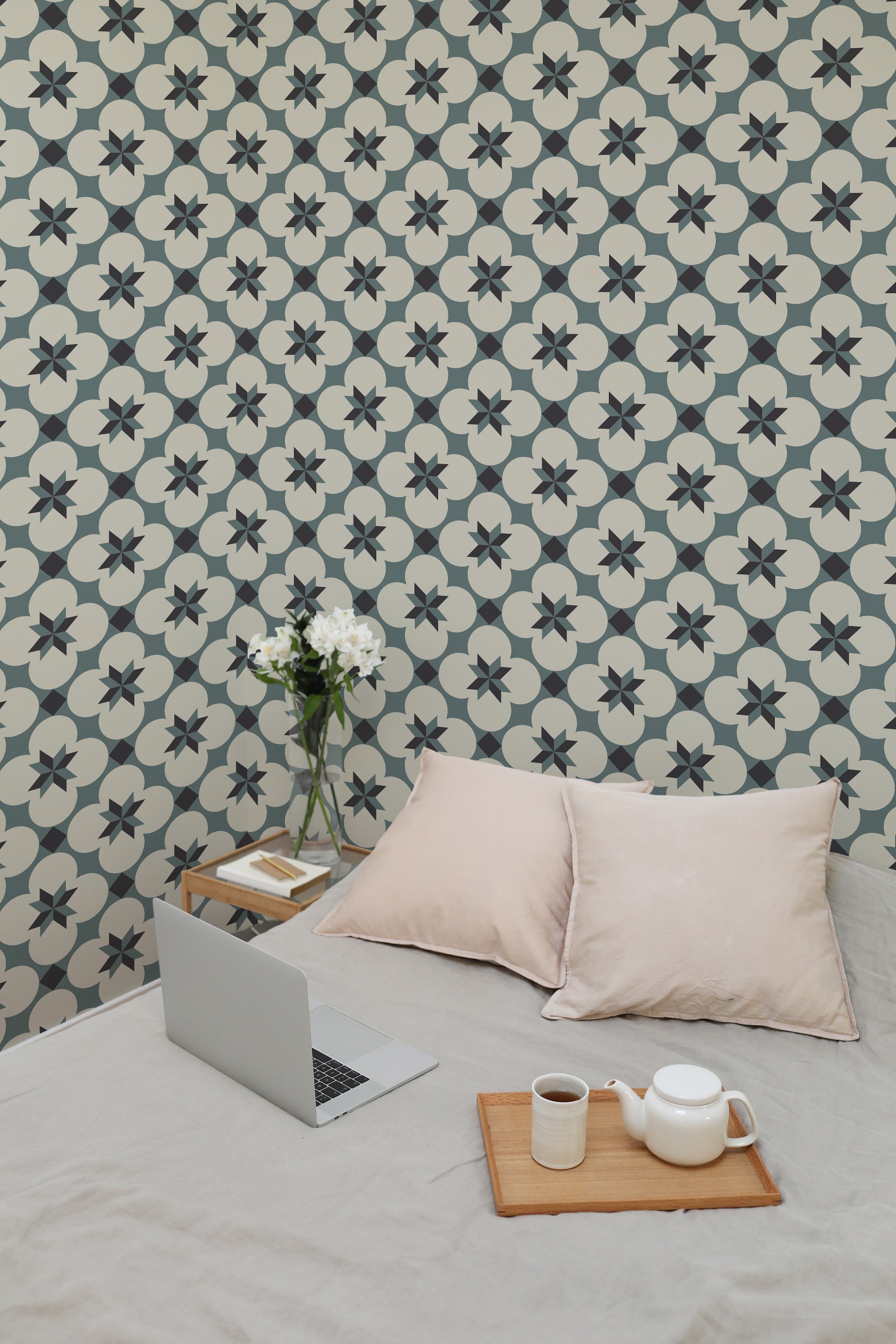 Self-adhesive blue tile wallpaper with star and cross patterns in a room with a laptop, books, teapot, and cushions.