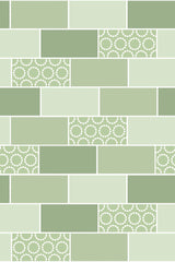 A pattern of alternating green tiles and decorative tiles with circular motifs, in shades of green, arranged in a brick layout. Peel and stick removable wallpaper.