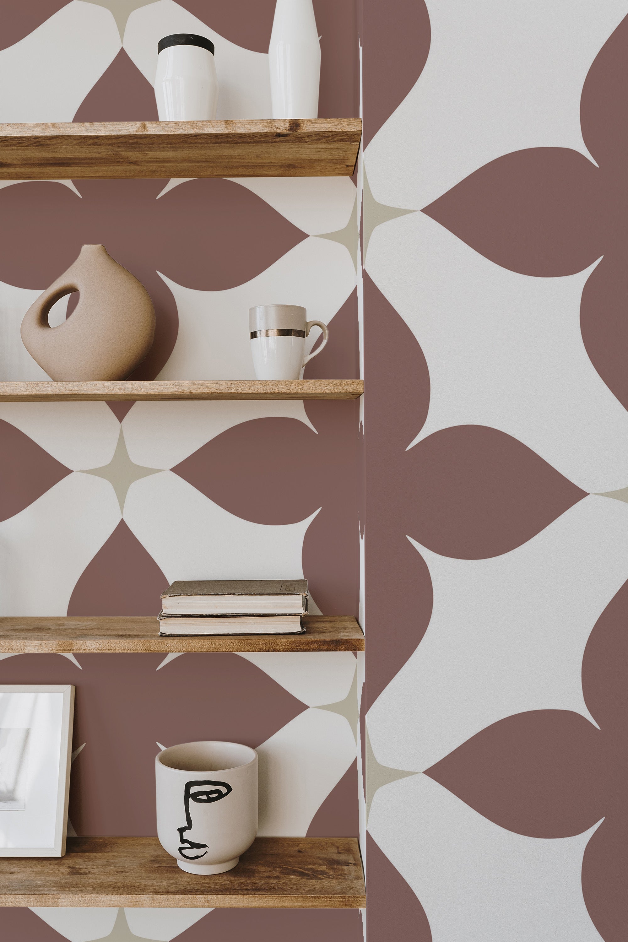Self-adhesive Bold tile wallpaper with overlapping circular patterns in shades of brown and beige on a wall, complemented by wooden shelves displaying various decorative objects.