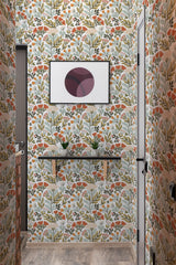 A room with walls covered in a traditional wallpaper pattern of stylized floral motifs in muted shades of orange, red, green, and gray on a cream background.